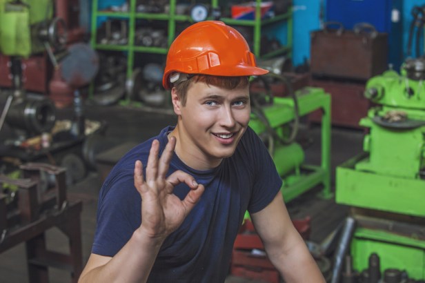 The young man working at the old factory on installation of equi